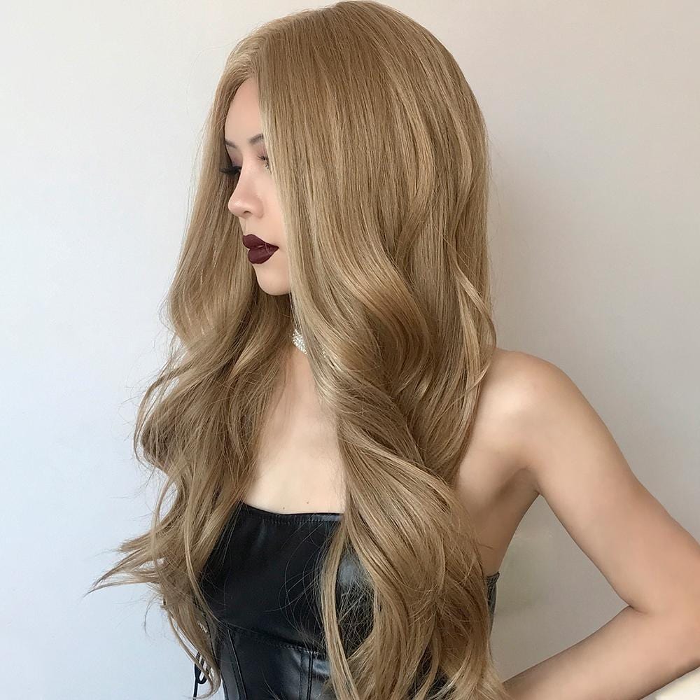 HAIRCUBE honey blonde lace front wig styled in long loose waves on model with black strapless top