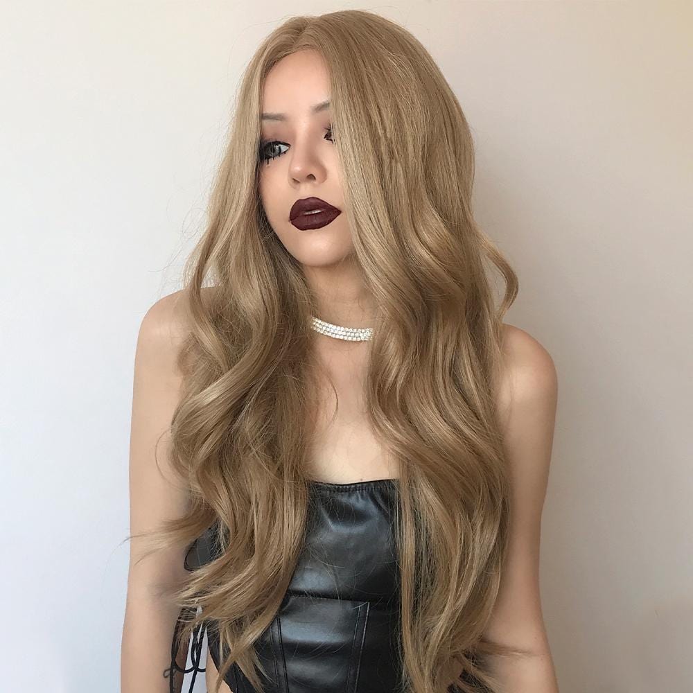 HAIRCUBE honey blonde lace front wig with long wavy hair styled on a model wearing a black top