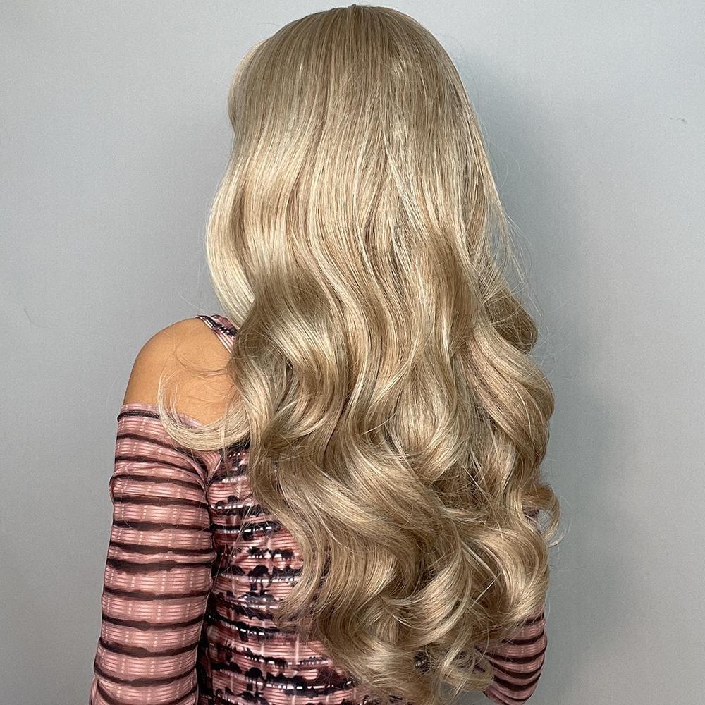 Alan long blonde curly wig with soft, voluminous curls displayed on a model wearing a striped top