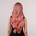 oneNonly long wavy pink wig shown from the back on a person wearing a black sleeveless top
