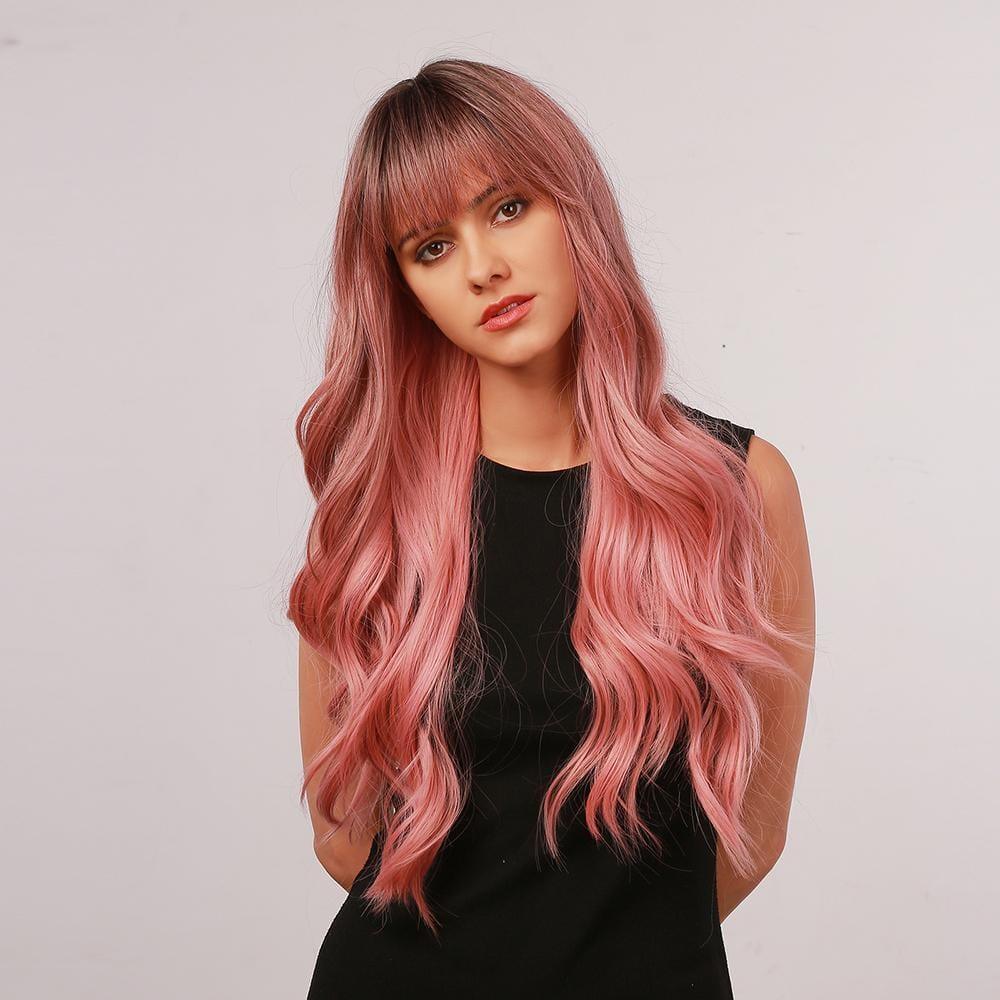oneNonly long wavy pink wig with bangs styled on a woman wearing a black sleeveless top