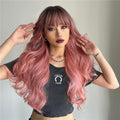 oneNonly long wavy pink wig styled with bangs on a model wearing a black cropped shirt