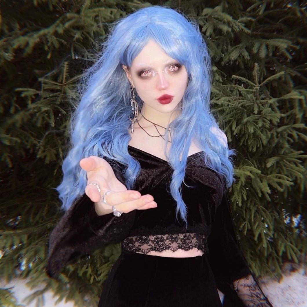 HAIRCUBE mermaid blue synthetic wig styled with soft waves on a model outdoors