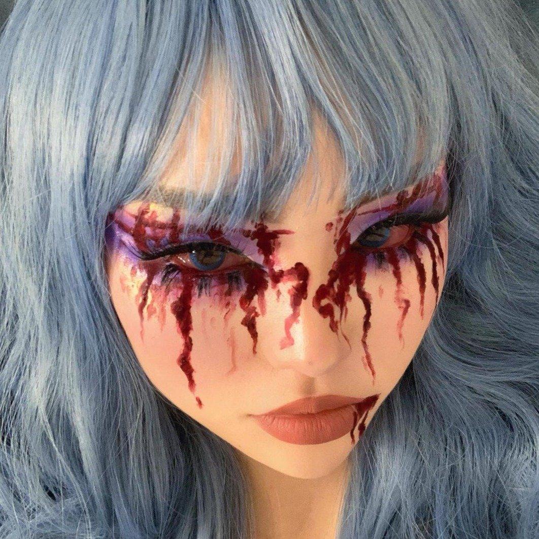 HAIRCUBE mermaid blue synthetic wig with long wavy hair and bangs styled on model