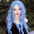 HAIRCUBE mermaid blue synthetic wig with long wavy hair styled on model outdoors