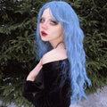HAIRCUBE mermaid blue synthetic wig with long wavy hair styled on a woman outdoors