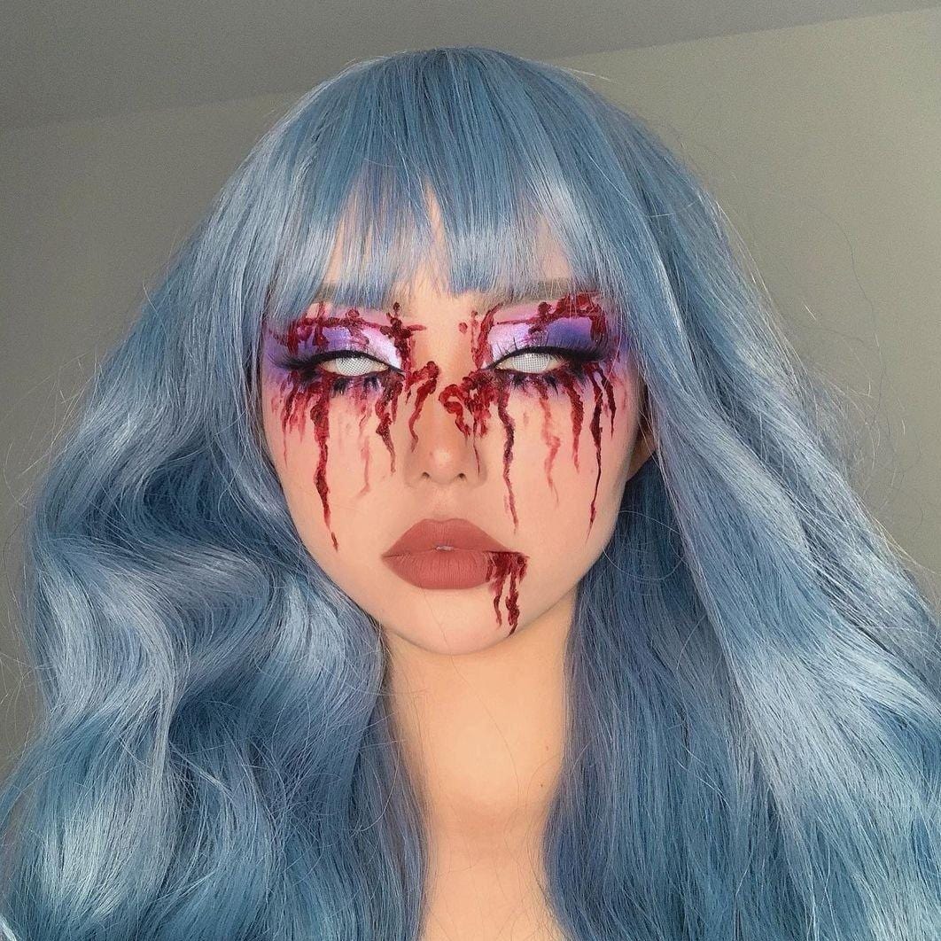 HAIRCUBE mermaid blue synthetic wig with long wavy hair and straight bangs styled on model